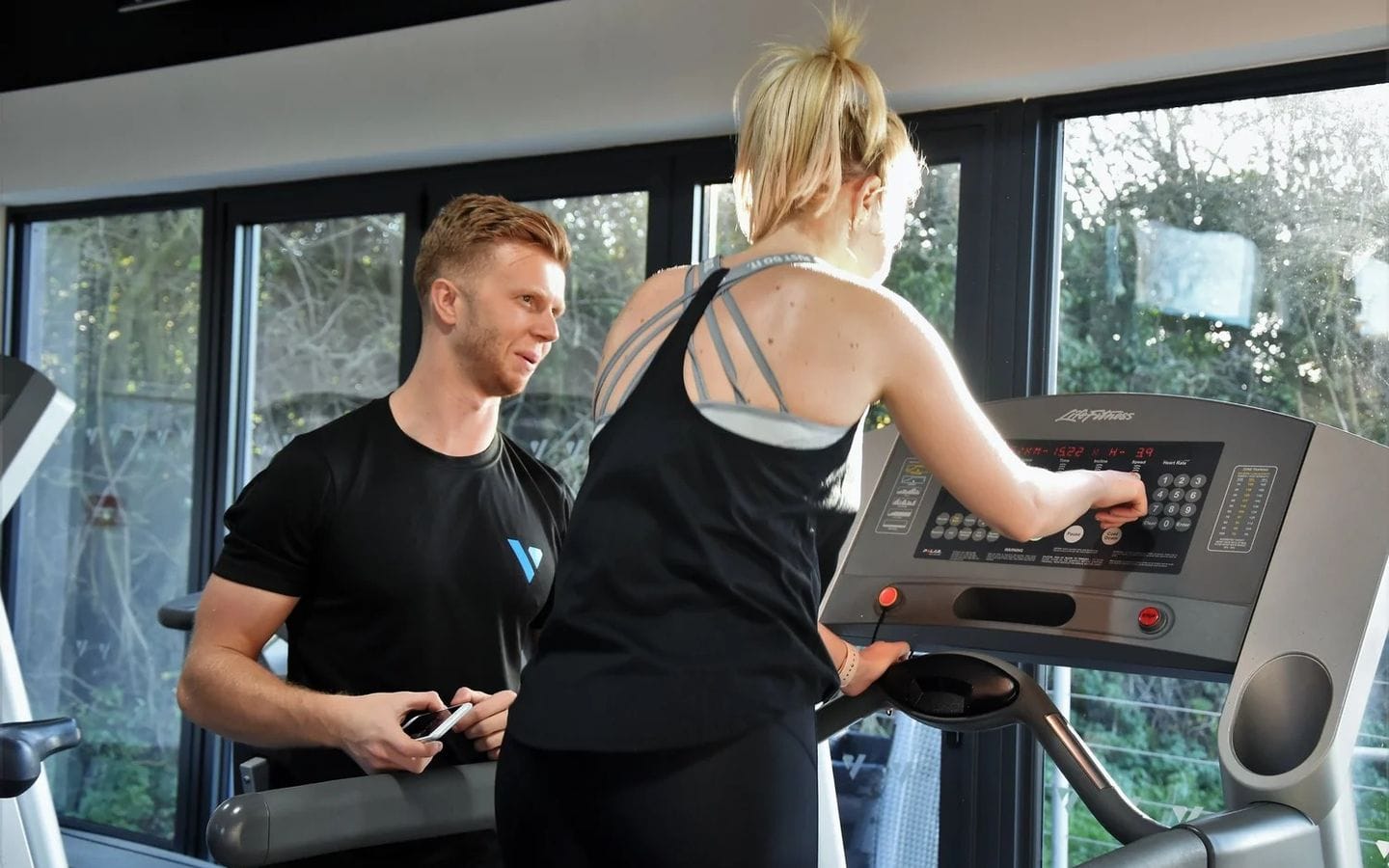 A Vision coach working one-to-one with a member on the treadmill at Vision Fitness Henham